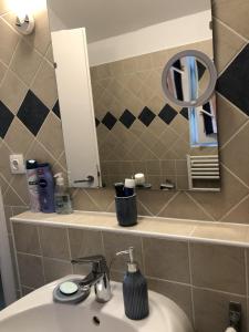 a bathroom with a sink and a mirror at Panoráma Villa in Balatonboglár