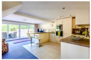 a kitchen with a counter and a table in it at Adorable 2 bedroom countryside guesthouse in Broom +8 photos