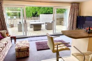 a living room with a couch and a table at Adorable 2 bedroom countryside guesthouse in Broom