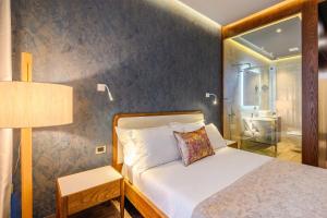 a bedroom with a bed and a bathroom at Chic Boutique Hotel Vlore in Vlorë