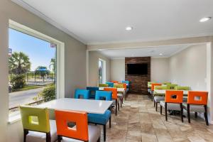 a waiting room with colorful chairs and tables at Days Inn by Wyndham Savannah Gateway I-95 in Savannah