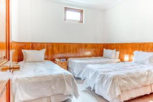 Кровать или кровати в номере CHALET CHAPITAL Punta Arenas