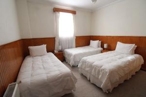 Кровать или кровати в номере CHALET CHAPITAL Punta Arenas