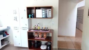 a room with a shelf with items on it at Praia de Itamambuca- Casa charmosa e iluminada in Ubatuba +127 photos