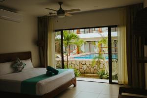 a hotel room with a bed and a balcony at Hotel Boutique Naj Casa Holbox in Holbox Island