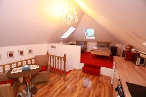 a attic room with a chandelier and a table at Strathbungo Studios in Glasgow