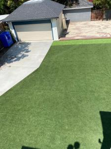 a yard with green grass and a garage at The Wilshire Metro in Los Angeles