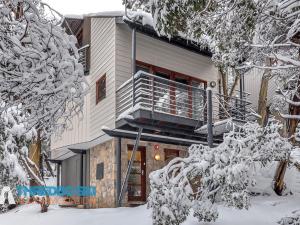 a house with a balcony in the snow at Mosswood 1 in Thredbo