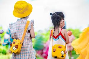 a young girl and a young boy wearing a hat and a toy car backpack at Horizon Resort & Spa Yalong Bay in Sanya