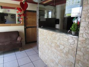 a kitchen with a stone counter and a chair at Ruma San Luis Hotel Boutique in San Luis Potosí