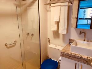 a bathroom with a shower and a toilet and a sink at Canto da Sereia in João Pessoa