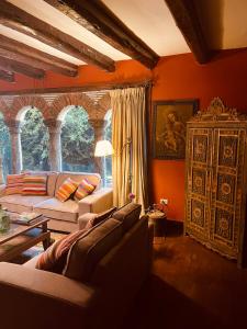 a living room with a couch and a table at Inka Tambo Hacienda in Cusco