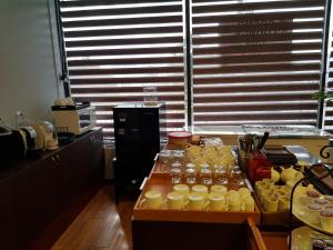 a kitchen with a table full of cups and jars at 1박전용 cosmo lounge 휴계실 in Saipan