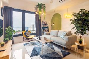 a living room with a couch and a table at Tropicana 218 X Airlevate Suites in George Town