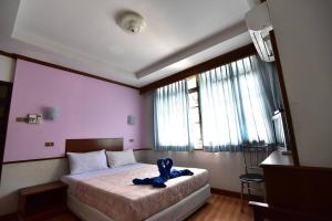 Postel nebo postele na pokoji v ubytování Krabi Grand Hotel