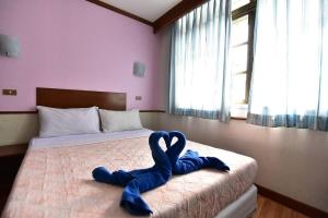 Postel nebo postele na pokoji v ubytování Krabi Grand Hotel