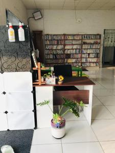 a desk in a library with a lot of books at 布袋愛琴海Aegean Sea B&B Budai in Budai +25 photos
