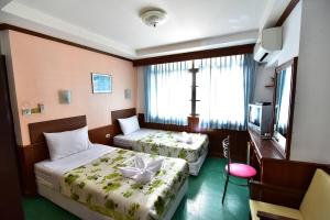 Postel nebo postele na pokoji v ubytování Krabi Grand Hotel
