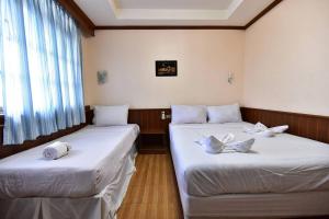 Postel nebo postele na pokoji v ubytování Krabi Grand Hotel