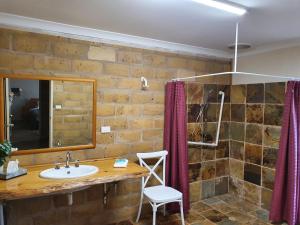a bathroom with a sink and a mirror at Little River Farm Cottages in Denmark +90 photos