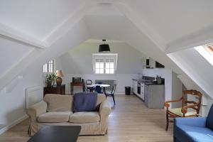 a living room with a couch and a table at Letabli in Ennetières-en-Weppes