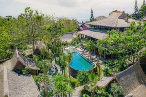 an aerial view of a resort with a swimming pool and trees at The Asa Maia - Bespoke Wellness Resort in Uluwatu