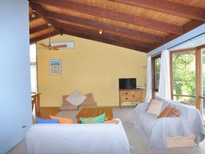 a living room with a couch and a table at Beechwood Surf Side in Inverloch