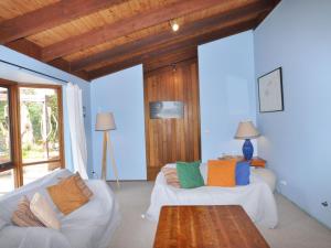 a living room with two white couches and a table at Beechwood Surf Side in Inverloch