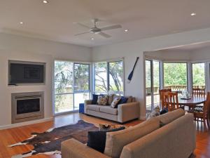 a living room with a couch and a fireplace at Scarborough Serenity in Inverloch