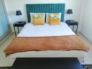 a bedroom with a large bed with two tables at iLOFT Loulé in Loulé