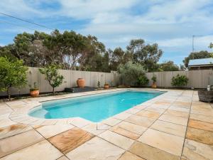 a swimming pool in a backyard with a fence at Coastal Villa on Beachcomber! in Inverloch