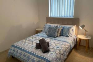 un dormitorio con una cama con un animal de peluche en CENTRAL CLOSE SHOPS CITY AIRPORT WIFI NETFLIX PARK en Perth
