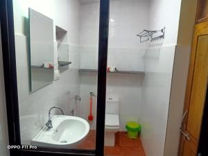 a bathroom with a sink and a mirror at Namaste Yoga Farm in Gokarna