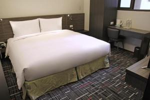 Postel nebo postele na pokoji v ubytování Capital Hotel SongShan