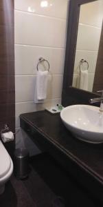a bathroom with a sink and a mirror and a toilet at HOTEL PITRASHISH PRIDE IGI Intl AIRPORT DELHI in New Delhi +57 photos