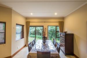 a dining room with a long table and chairs at Zimbali Holiday Home - 3 Baluwatu in Durban