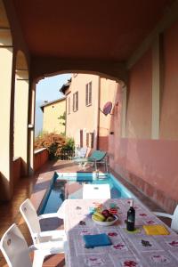 a table and chairs on a patio with a swimming pool at Antico Borgo Camporeso in Galbiate