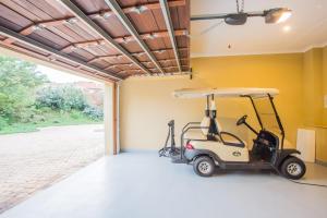 a golf cart parked inside of a garage at Zimbali Holiday Home - 3 Baluwatu in Durban