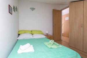 a bedroom with a bed with two towels on it at Apartment Lala in Dubrovnik