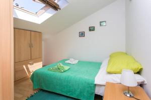 a bedroom with a bed with a green blanket at Apartment Lala in Dubrovnik