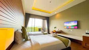 a bedroom with two beds and a large window at Vivace Khaoyai in Mu Si