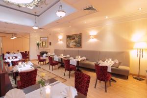 a restaurant with tables and chairs in a room at Branicki Boutique Rooms in Białystok