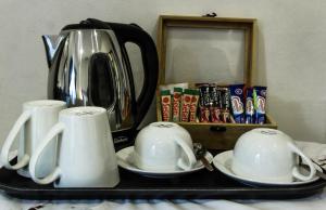 a black tray with two mugs and a tea kettle at Charlie's Spot - Norwood in Johannesburg
