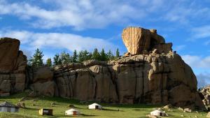 a large rock formation with houses in front of it at Four Season in Ulaanbaatar