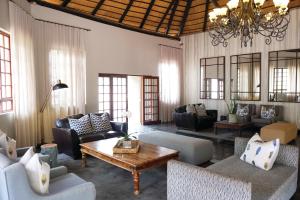 a living room with couches and a coffee table at Premier Hotel Roodevalley in Pretoria