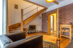 a living room with a couch and a brick wall at Apartmány no.823 in Bublava