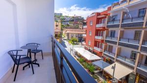 a balcony with a table and chairs and buildings at DWO Nopal in Puerto de la Cruz