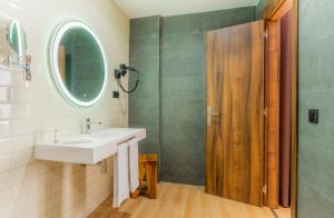 a bathroom with a sink and a shower and a mirror at DWO Nopal in Puerto de la Cruz