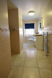 a bathroom with a shower and a toilet and a sink at Royal Southern Yacht Club in Hamble