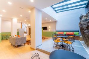 a room with a table and chairs and a couch at DWO Nopal in Puerto de la Cruz